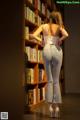 A woman standing in front of a bookshelf in a library.