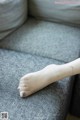 A woman's bare foot with a gold bracelet on it.