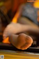 A close up of a person's foot on a piano.