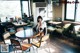 A woman sitting at a table in a restaurant.